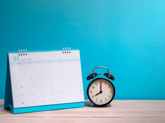 Blue background with calendar and alarm clock