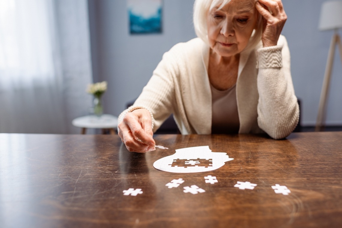 Older woman doing jigsaw puzzle