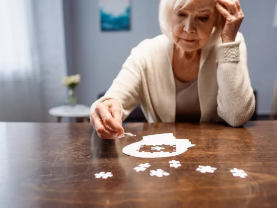 Older woman doing jigsaw puzzle