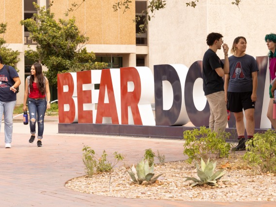 Students in front of Bear Down sign