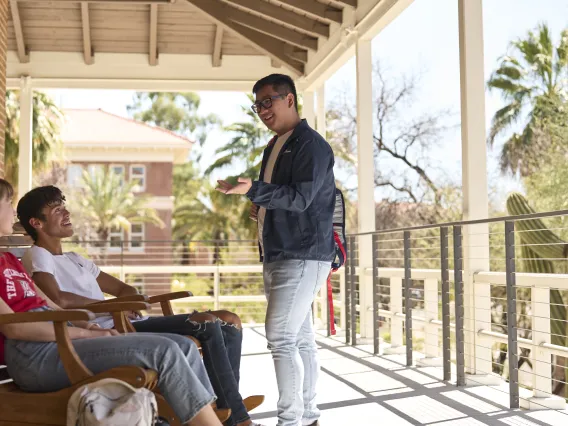 hree students on old main porch