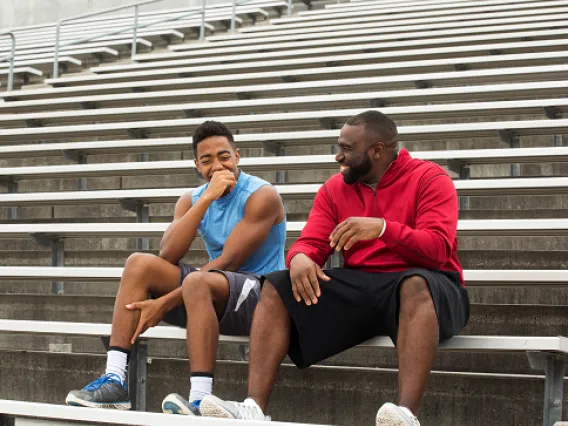 Coach spending time mentoring a student athlete