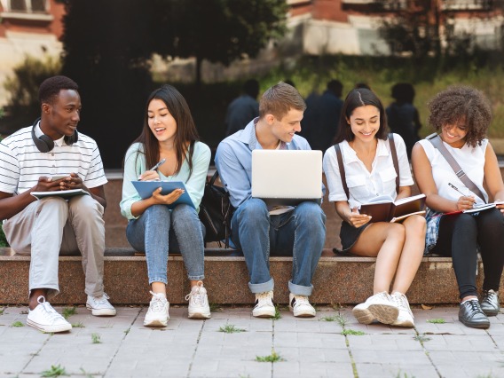 students sitting on curb