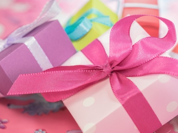 Pastel-colored gift boxes with ribbon in a pile