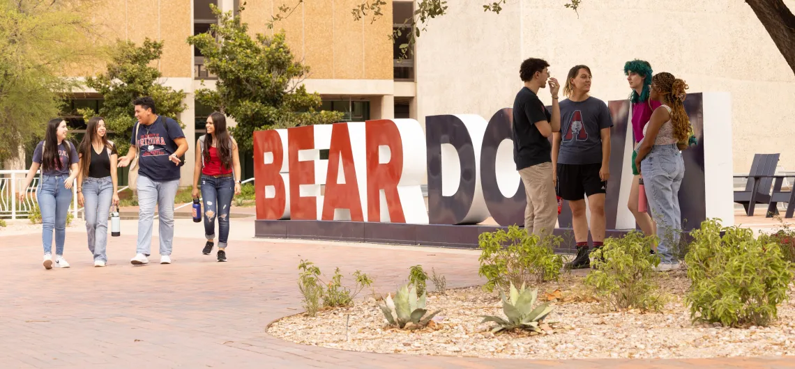 Students in front of Bear Down sign