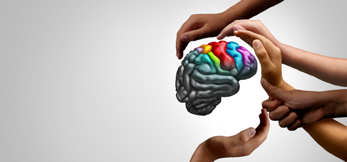 student hands around colorful brain