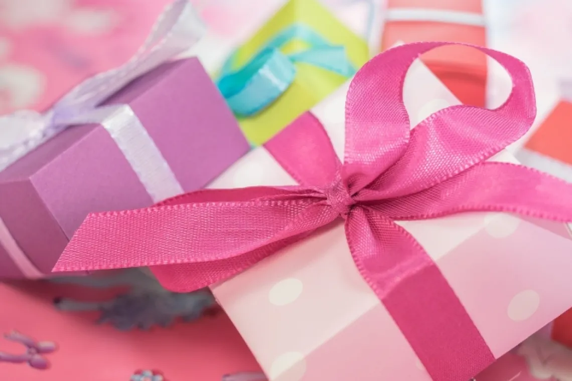 Pastel-colored gift boxes with ribbon in a pile