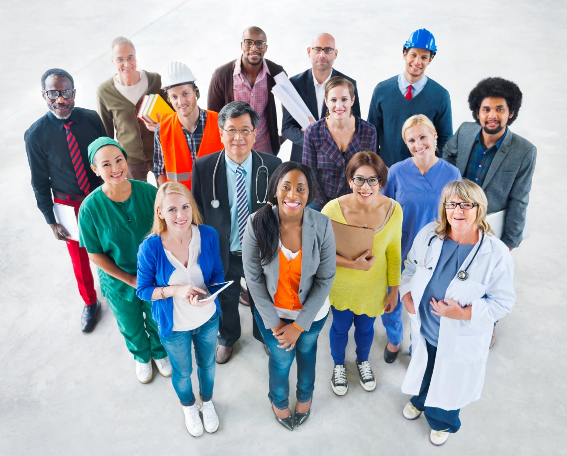 Group of diverse people standing together looking up at camera