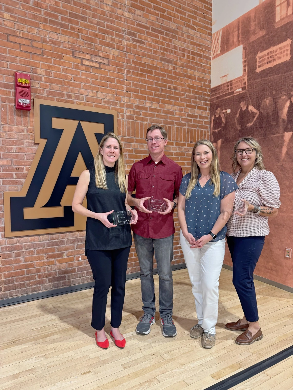 Psychology faculty members Christy Ball, Adam Lazarewicz, Ashley Jordan, & Linda Hollis standing with their Teaching Mentoring awards