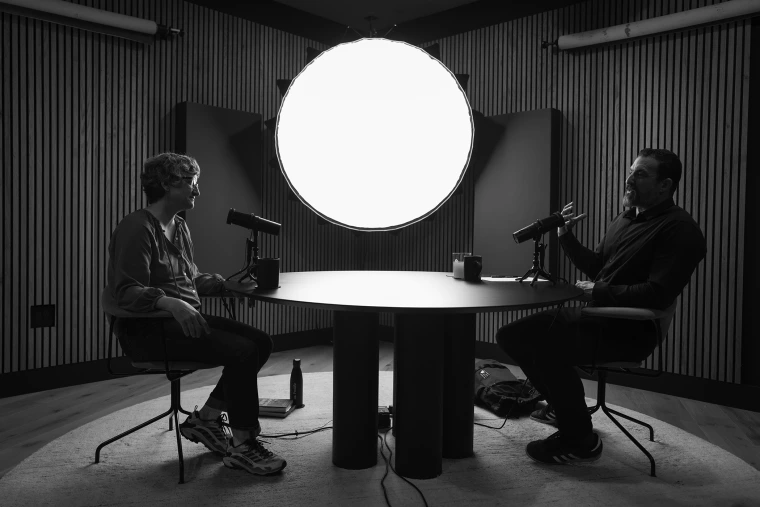 Black & white photo of U of A faculty member Mary-Frances O'Connor across the table from host Ian Mackey during Huberman Lab podcast recording