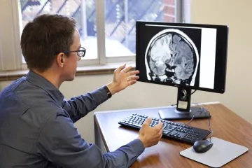 professor matt grili discussing brain image on computer