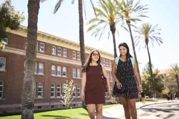women in front of old main
