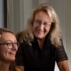 News - Barnes - Brain Research for the Ages - blonde female student, brunette female student with glasses, Carol Barnes smiling in front of computers at U of A