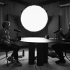 Black & white photo of U of A faculty member Mary-Frances O'Connor across the table from host Ian Mackey during Huberman Lab podcast recording